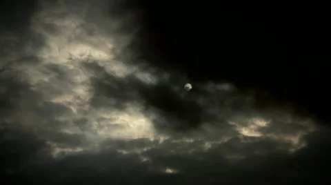 Sun hides behind dark storm clouds time lapse with light rays Stock Footage 49943432