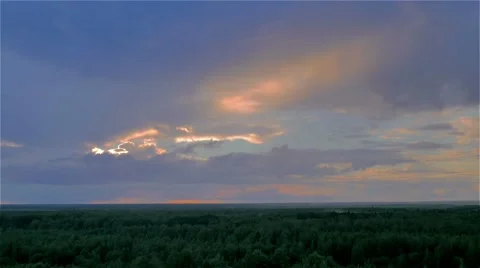 Sun hides behind storm rain cloud over green summer forest. aerial timelapse Stock Footage 66241220