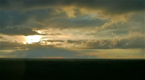 Sun hides behind storm rain cloud over green summer forest. aerial timelapse Stock Footage 66241245