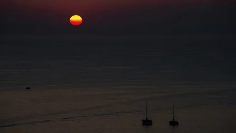 Sun hiding behind the mountain in Santorini, Greece Stock Footage 75576373
