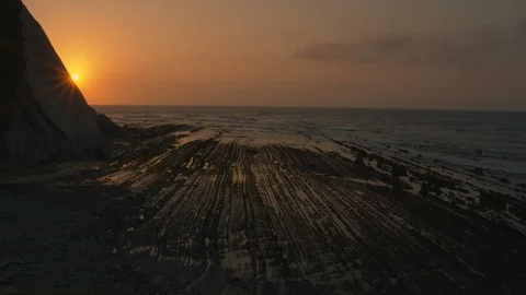 Sun hiding behind mountain at sunset in flysch Stock Footage 112295316