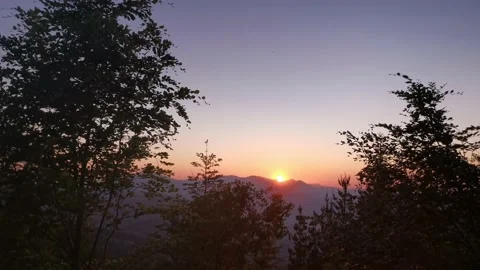Sun hiding behind the mountains Stock Footage 131458725