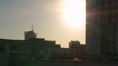 Sun hiding behind the skyscrapper drone shot. Stock Footage 89637238
