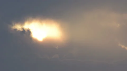 Sun hiding between clouds moving in Time Lapse at sunset Stock Footage 212107934