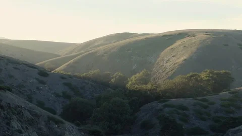 Sun hitting top of the hills Stock Footage 88286732