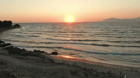 Sun at the horizon over waves at beach Stock Footage 137563534