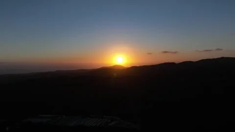 Sun Hovering Over Mountain Silhouette at Sunset – Gran Canaria Aerial Stock Footage 309940516