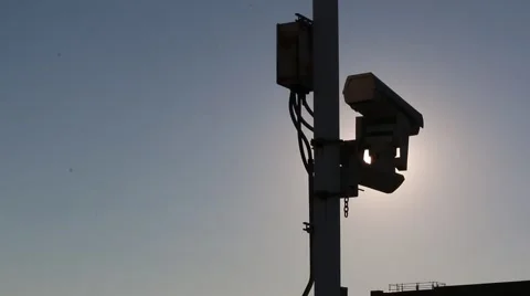 Sun illuminated behind security/traffic camera Stock Footage 45562829