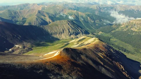 The sun illuminates the colors of the mountain peaks in Colorado Stock Footage 247363839