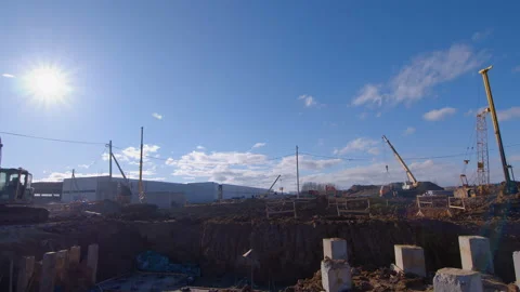 The sun illuminates the construction site at the stage of initial earthwork  Stock Footage 161952596