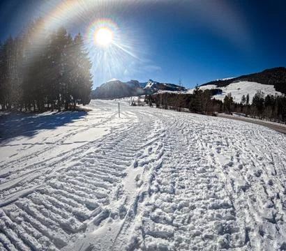 The sun illuminates the snow-capped Monte Bondone in Trentino, Italy Stock Photos