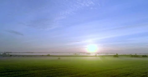 The sun is illuminating a green field with rays. Stock Footage 76771876