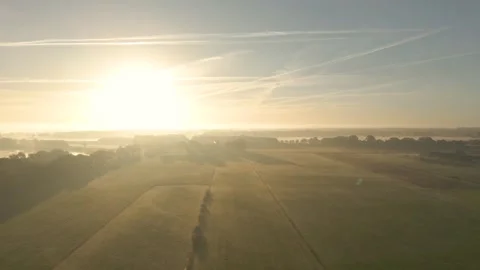 Sun illuminating misty countryside fields Stock Footage 293158126