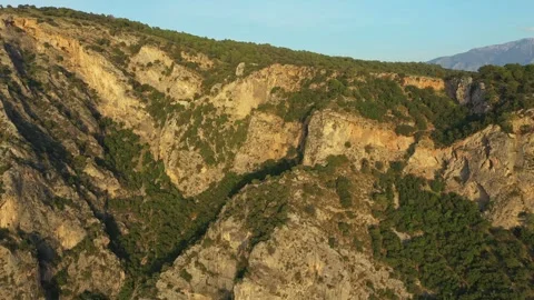 Sun illuminating monastery built into mountainside Vídeo Stock 311022405