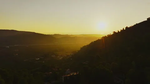 Sun illuminating mountain valley at sunset Stock Footage 300620126