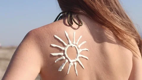 Sun image made with sunscreen on woman's back. Sunbathing Stock Footage 315533123