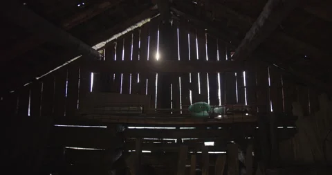 Sun leaking through an old wooden barn Video stock 230236808
