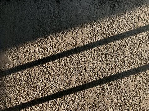 Sun Light and Stripe shadow on rough white wall Stock Photos