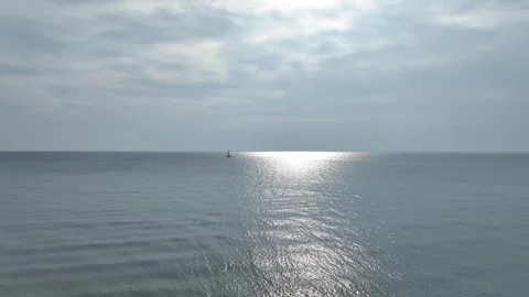 Sun Light on Calm Lake with Passing Motorboat Stock Footage 248929858