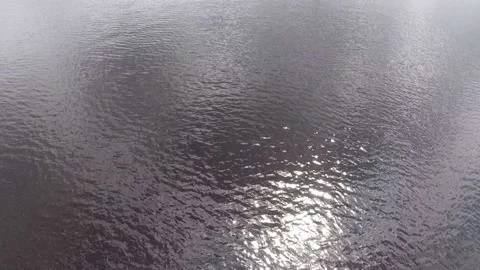 Sun light flare on dark water surface background Stock Footage 156596533