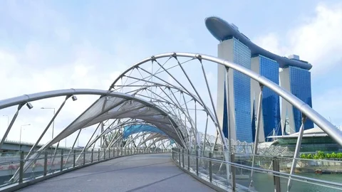 Sun light helix bridge walking tourist marina bay sands view Singapore Stock Footage 80394191