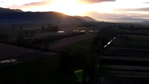 Sun light over a mountain and crop fields Stock Footage 98456858