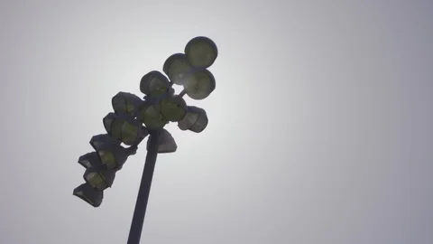Sun light peaking by stadium lights Stock Footage 103867540