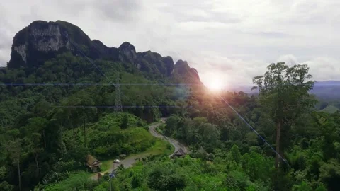 Sun light ray flare n bokeh sunbeam effect at Lust green mountain Stock Footage 153468566