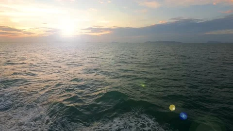 Sun light ray flare n bokeh sunbeam over sea water n ocean wave Stock Footage 153913005
