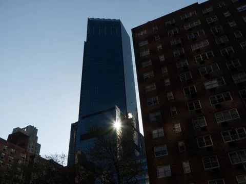 Sun light reflection in glass facade of a tall building Stock Photos