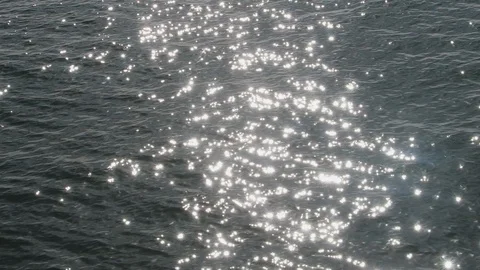 The sun light reflects off of small waves in the calm sea. Stock Footage 119181414