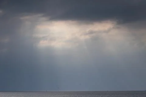 Sun Light shining through  the gaps in clouds before sun set , Crepuscular rays Stock Photos