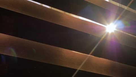 Sun light is shining through the window blinds - sun lens flare, close up view Stock Footage 341316630