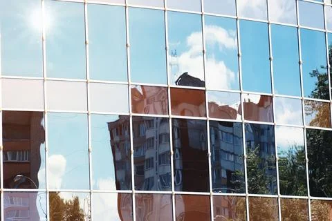Sun light sky cloud reflection in glass office building Stock Photos