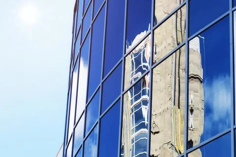 Sun light sky cloud reflection in glass office building Stock Photos