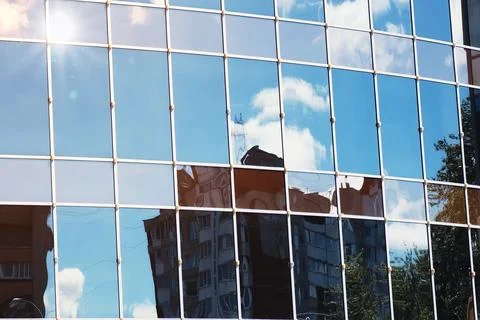 Sun light sky cloud reflection in glass office building Stock Photos