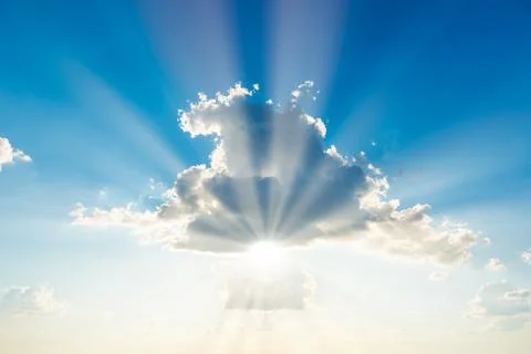 Sun light through cloud on blue sky Стоковые фото