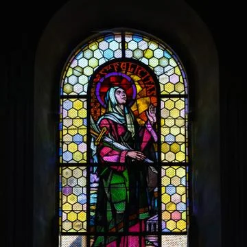 Sun light through the leaded pane in old majestic church Stock Photos