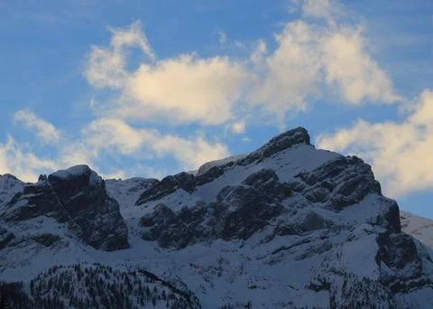 Sun lit clouds over Mount Schluchhore in winter. Stock Photos