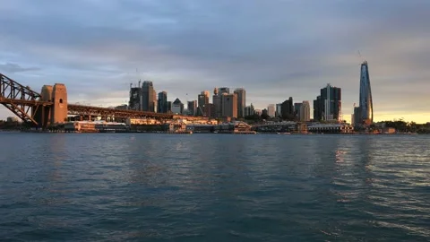 Sun lit sunset in Sydney over city CBD landmarks on shores of Harbour as 4k. Stock Footage 139242537