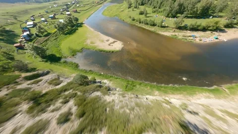 Sun-lit valley with winding river. The sun is reflected on the surface of the Stock Footage 156539583