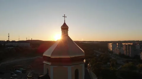 The sun looking out from behind church dome. Aerial shot. Sunset. Stock Footage 145753553
