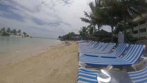 Sun loungers on a beach Stock Footage 138643651