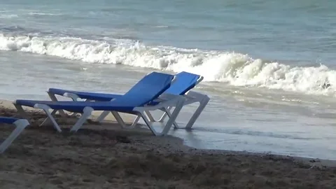 Sun loungers on the beach with waves 스톡 동영상 138874064