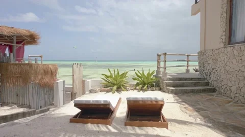 Sun loungers in perfect setting overlooking the sea on tropical island Stock Footage 148530088