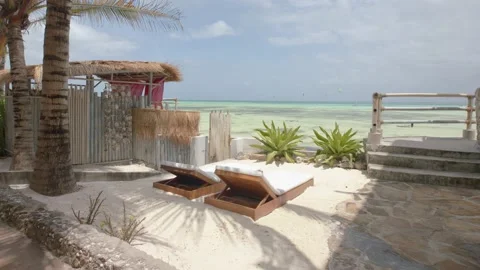 Sun loungers in perfect setting overlooking the sea on tropical island Stock Footage 148530209
