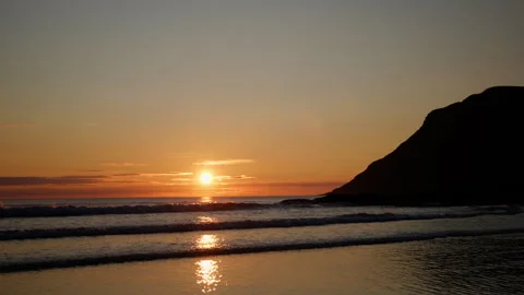 Sun Low on Horizon Over Nordic Beach Surf and Headland Vídeo Stock 340574566