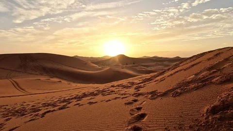 Sun low over the sculpted dunes of Erg Chebbi, Merzouga, Morocco, warm sunset Stock Footage 344532646