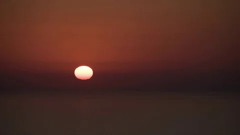Sun melting in the sea in Mallorca at sunset - timelapse Stock Footage 75576343