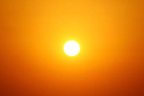 The sun is in the middle of an orange sky. Empty sky, suitable for copy spa.. Stock Photos